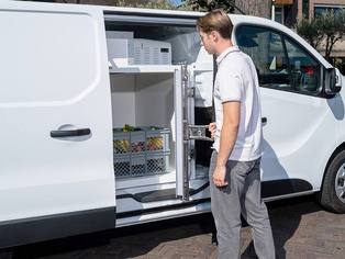 Fahrzeug Seitenansicht mit geöffneter Schiebetür, durch die eine geöffnete VEBA-Kühlbox im Fahrzeuginnern zu sehen ist.